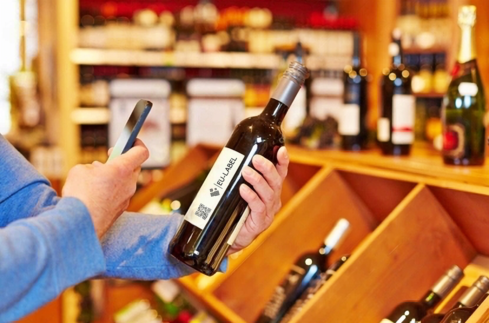 Man scanning with a smartphone qr code on bottle of wine - Eu-Label.info